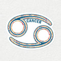 A Cancer zodiac sign sticker featuring a stylized astrological symbol with a colorful patterned border and the word 'CANCER' in blue, shown on a textured off-white background.