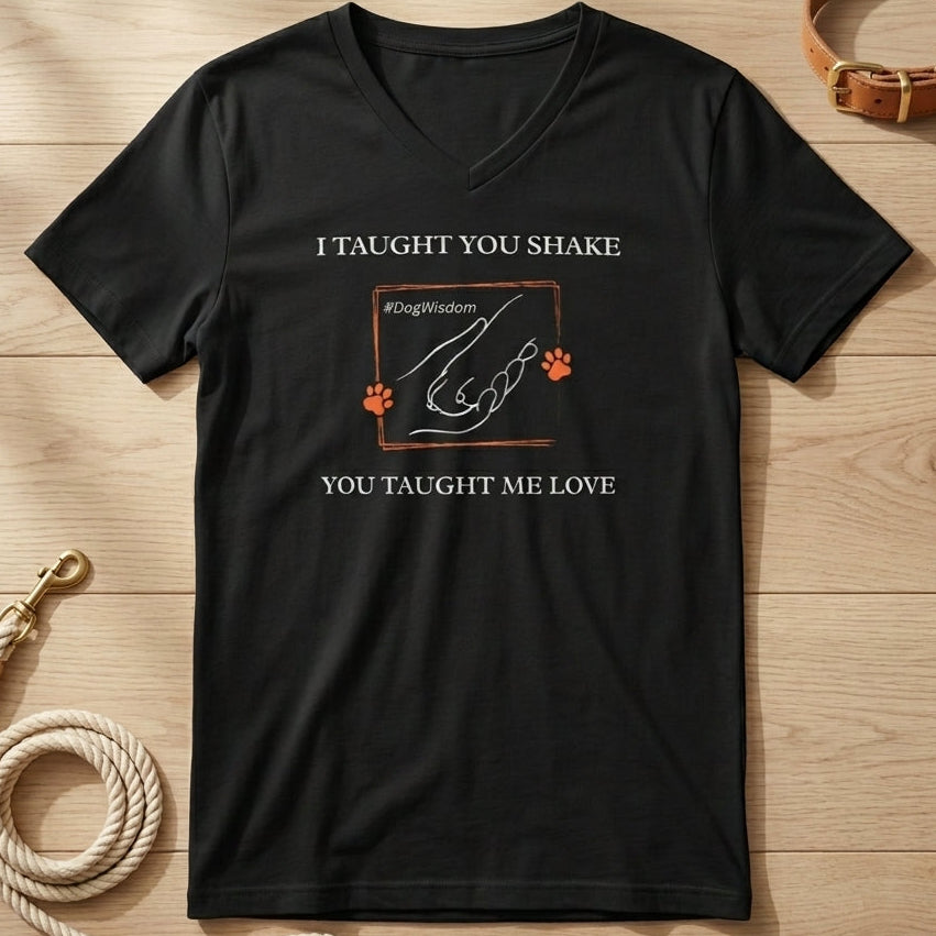Black t-shirt with dog-themed graphic and text on a wooden surface with a dog collar and leash.